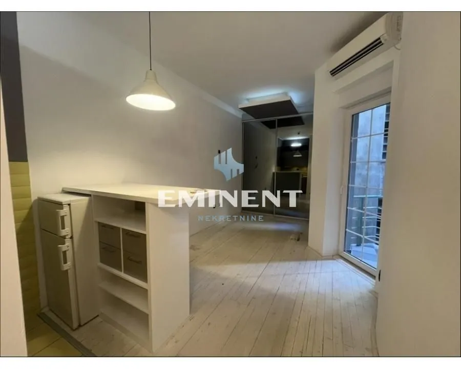 Smaller kitchen with a counter and dining area.