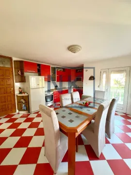 Kitchen with a dining area and red and white ceramic floor tiles. - image 5