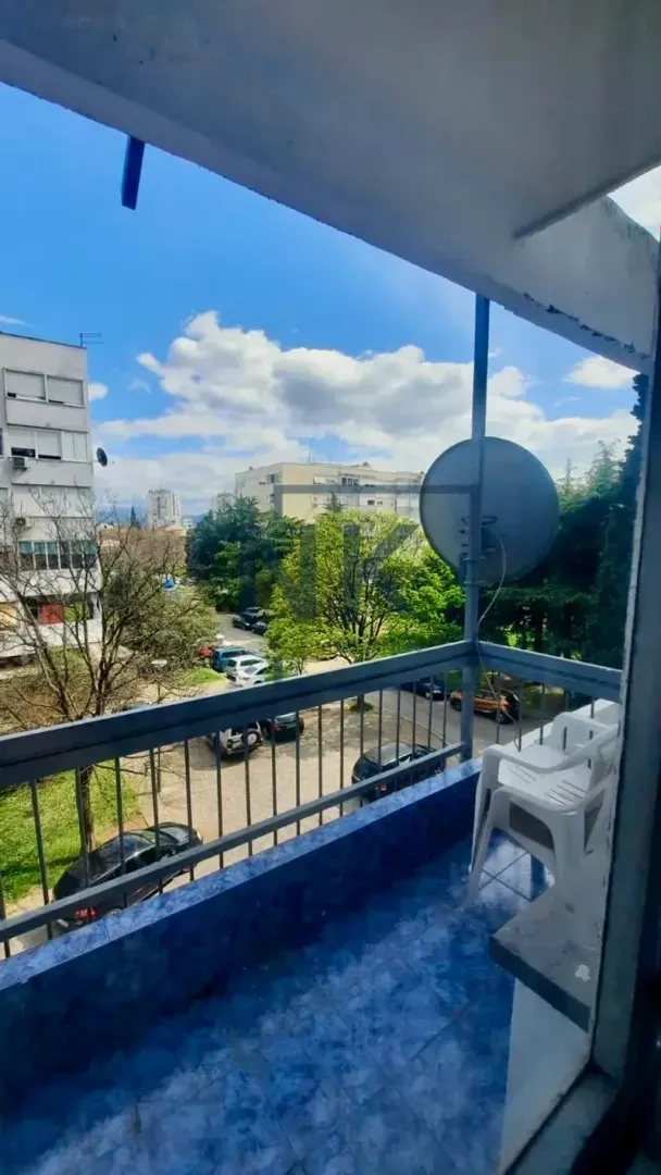 Smaller balcony with a view of surrounding buildings and greenery.