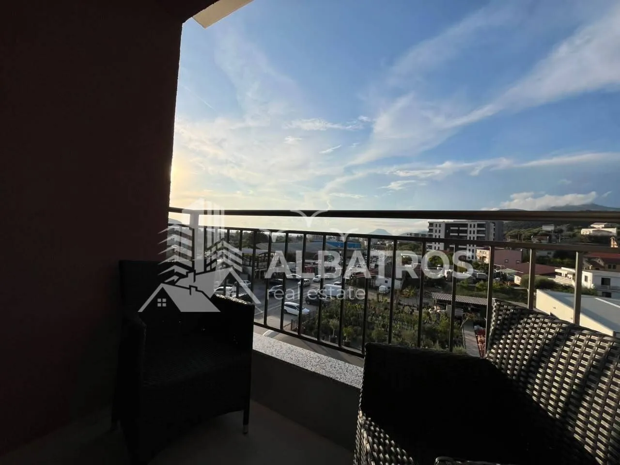 Furnished balcony with seating set and view of the surroundings.