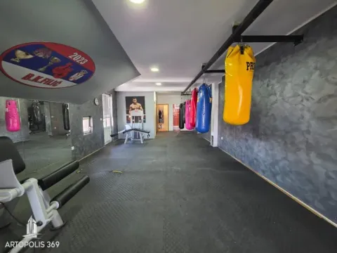 Interior of a gym with punching bags and exercise equipment. - image 5