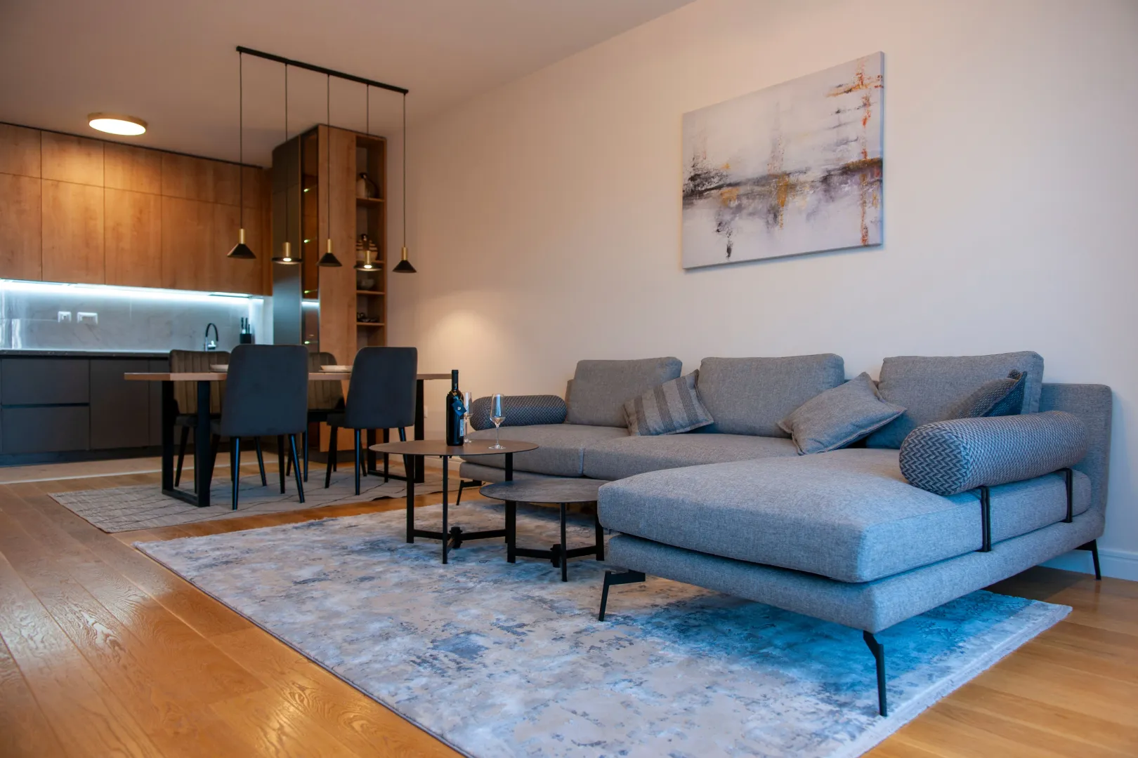Living room with a sofa set and an adjoining dining area.