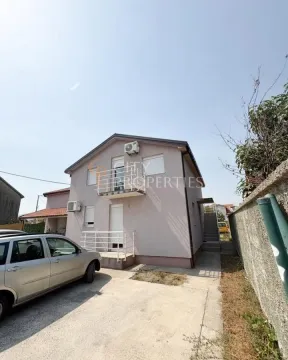 View of the exterior of the house with a courtyard and parking space. - image 2
