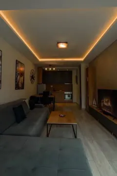 Living room with sofa and dining area in the background. - image 3