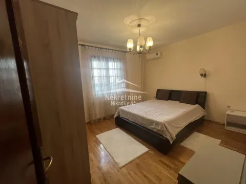 Furnished bedroom with a double bed, wardrobe, and window. - image 14