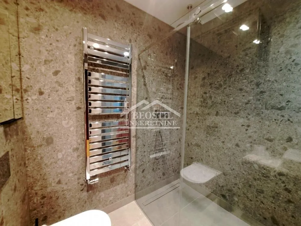 Modern bathroom with a shower cabin and built-in fixtures.