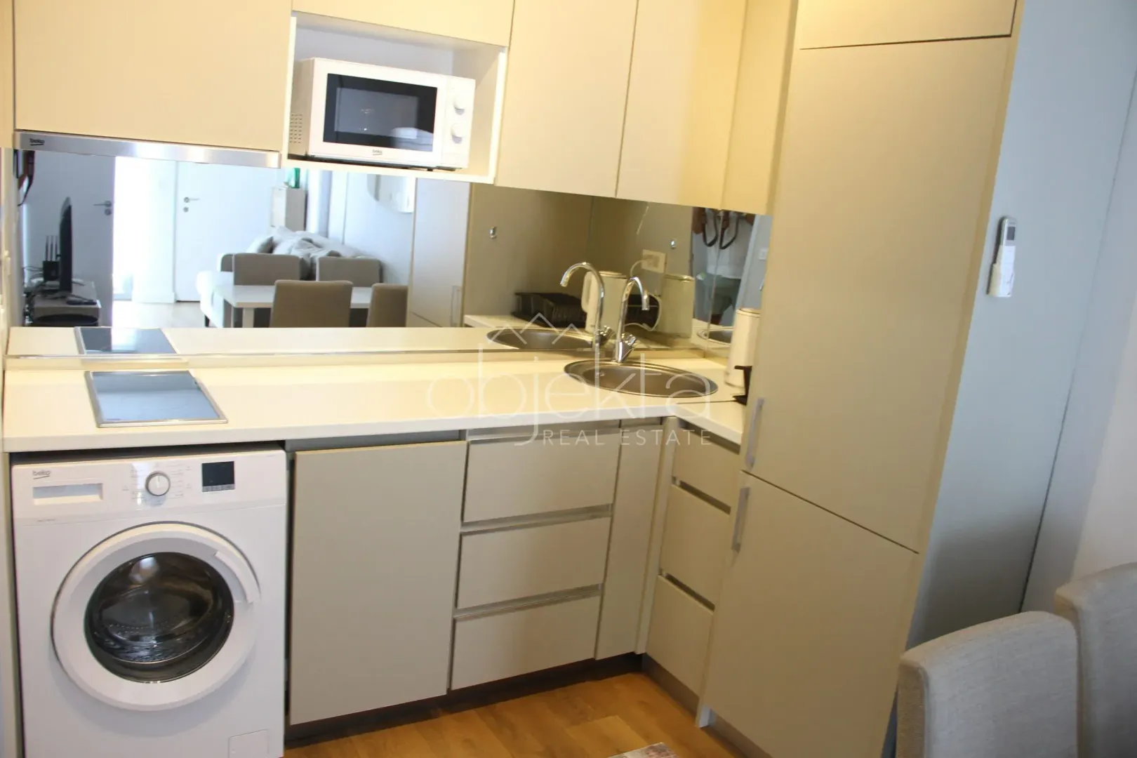Compact kitchen with built-in units and a washing machine.