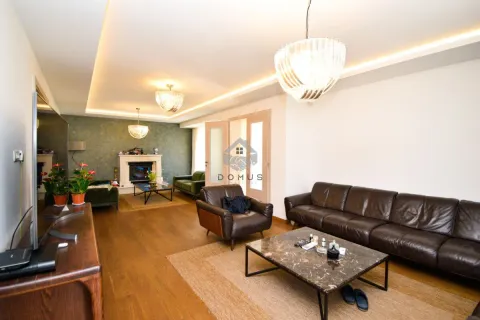 Spacious living room with seating furniture and a fireplace. - image 9