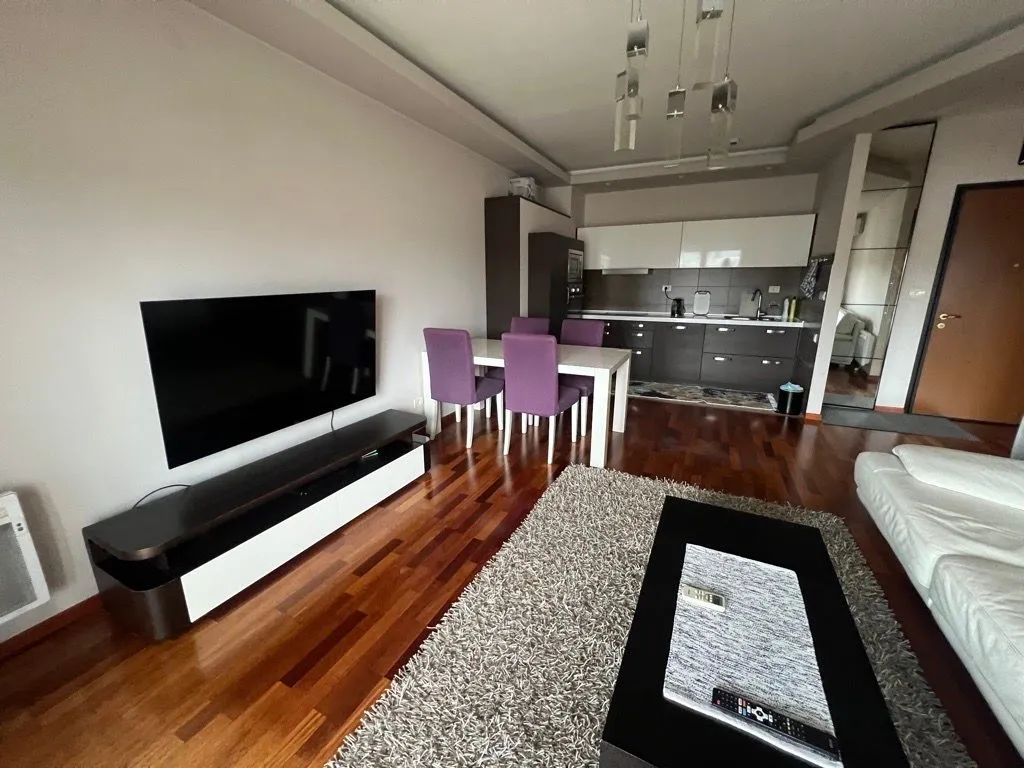 Living room with dining area and kitchen in the background.