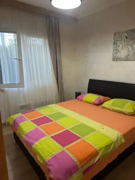 Furnished bedroom with a double bed, window, and a painting on the wall. - image 12