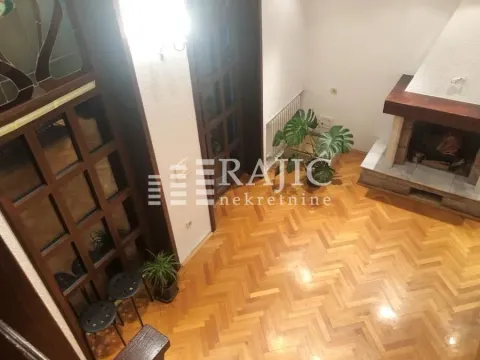 Living room with a fireplace, wooden floor and staircase. - image 4