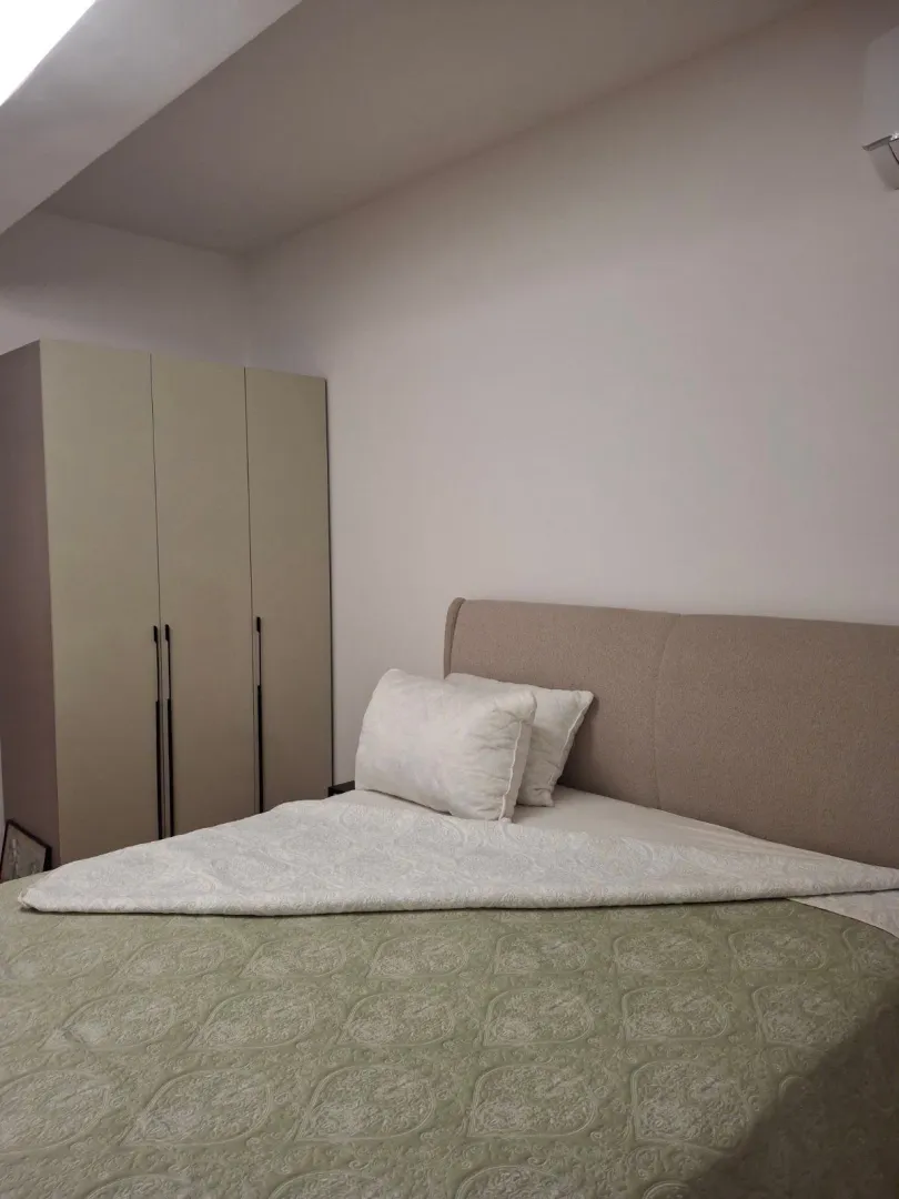 Bedroom with a double bed and a wardrobe.