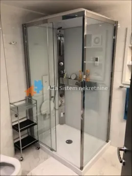 Bathroom with a shower cabin and shelves. - image 19