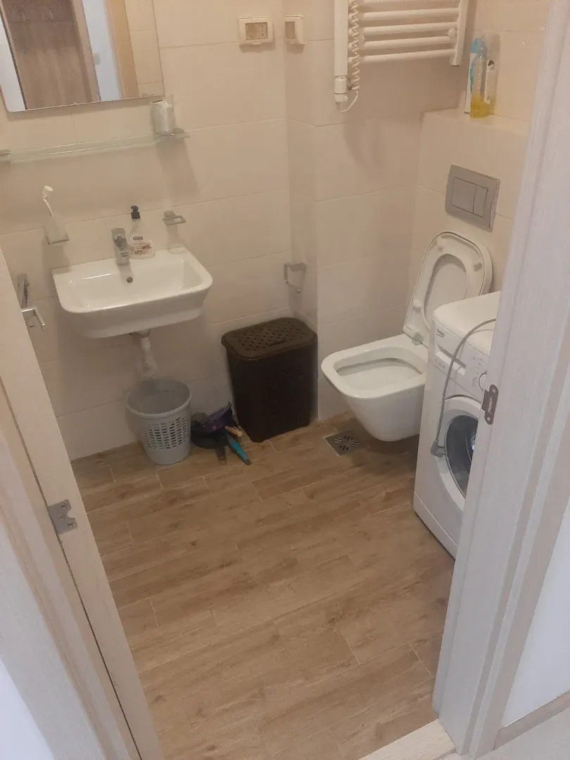 Small bathroom with a washing machine and sink.