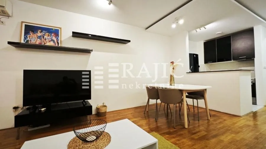 Living room with dining area and a view of the kitchen.