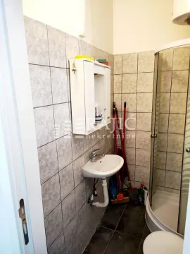 Small furnished bathroom with a shower cabin and a sink. - image 7