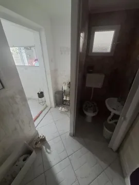 View of the bathroom with a toilet and washbasin. - image 8
