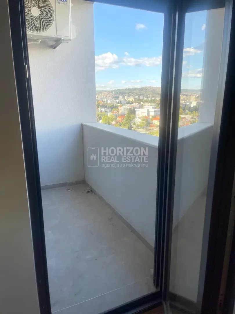 Small bright balcony with a city view.