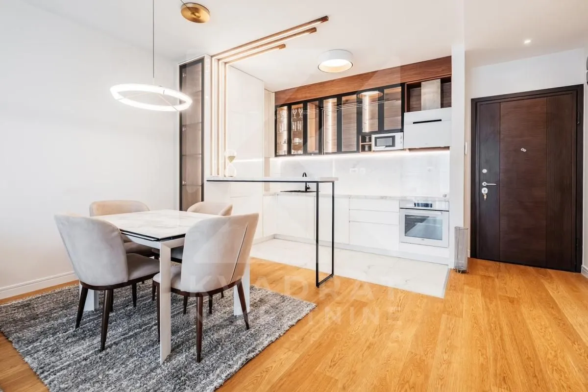 Modern kitchen with dining area and built-in appliances.