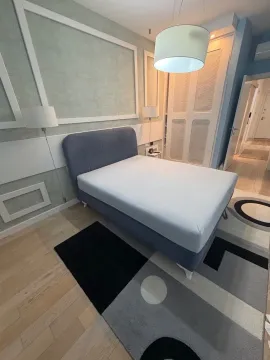 Modern bedroom with a double bed, wardrobe, and rug. - image 6