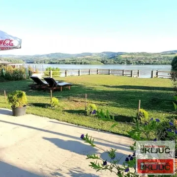 Yard with a river view and sun loungers. - image 4