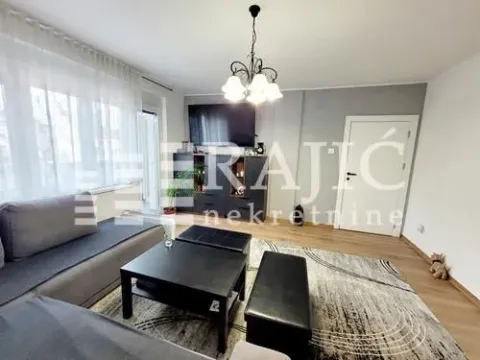 Spacious living room with a sofa and TV. - image 19