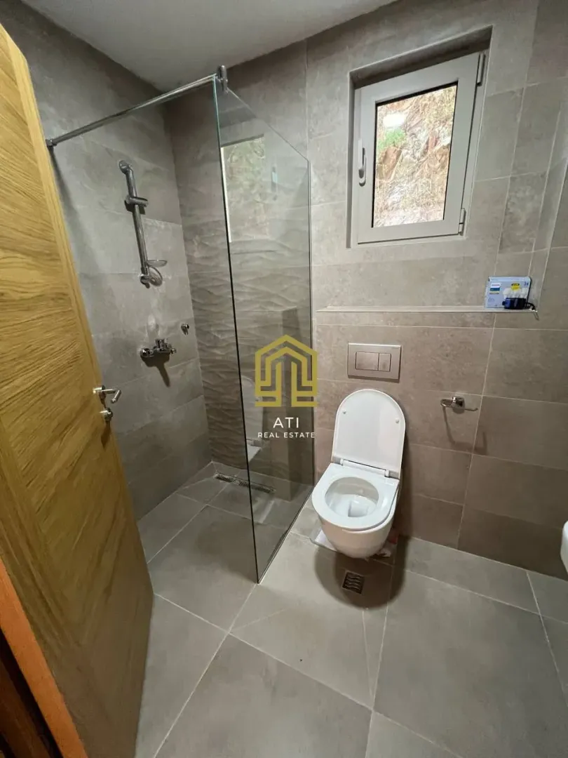 Modernly equipped bathroom with a walk-in shower.