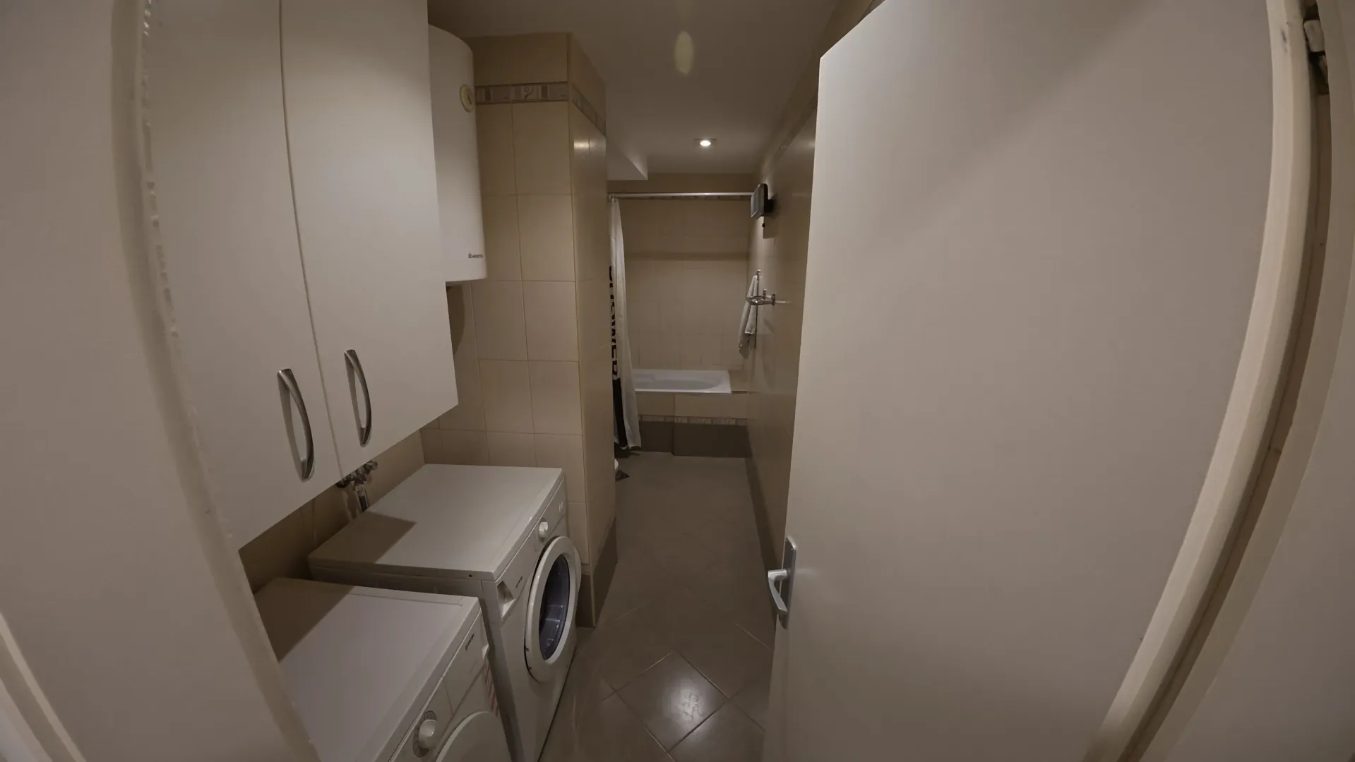 Small bathroom with a bathtub and white fixtures.