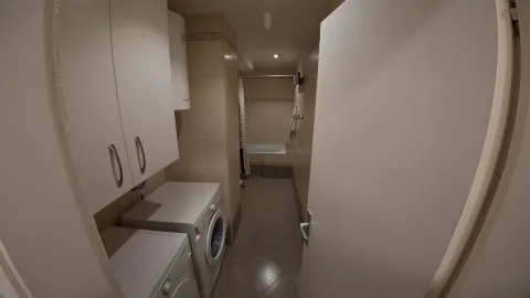 Small bathroom with a bathtub and white fixtures. - image 5