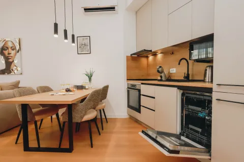 Modern kitchen with a dining area and built-in appliances. - image 3