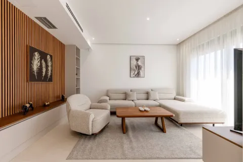 Modern living room with a sofa set, wooden coffee table, and decorative wall panels. - image 9