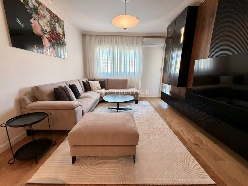 Modern and bright living room with a sectional sofa and a large TV.