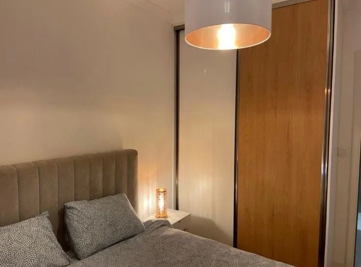 Furnished bedroom with a double bed and built-in wardrobe.