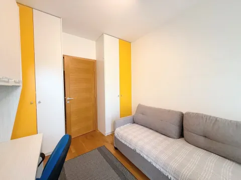 Smaller bedroom with a bed, wardrobes, and a desk. - image 7