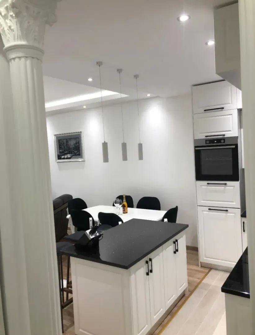 Modern kitchen with an island and dining area in the background.