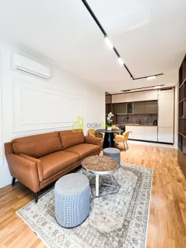 Living room with a sofa and an adjoining dining area. - image 10