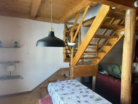 Living room with wooden stairs and ceiling. - image 4