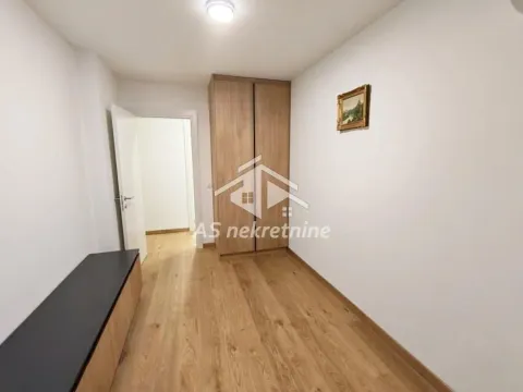 Small bedroom with a built-in wardrobe and wooden flooring. - image 13