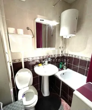 Small bathroom with sanitary fixtures, sink, and bathtub. - image 11