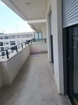 Spacious covered balcony with metal railing and neighborhood view. - image 6