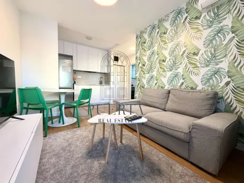 Living room with sofa and dining area in an open-plan layout. - image 2