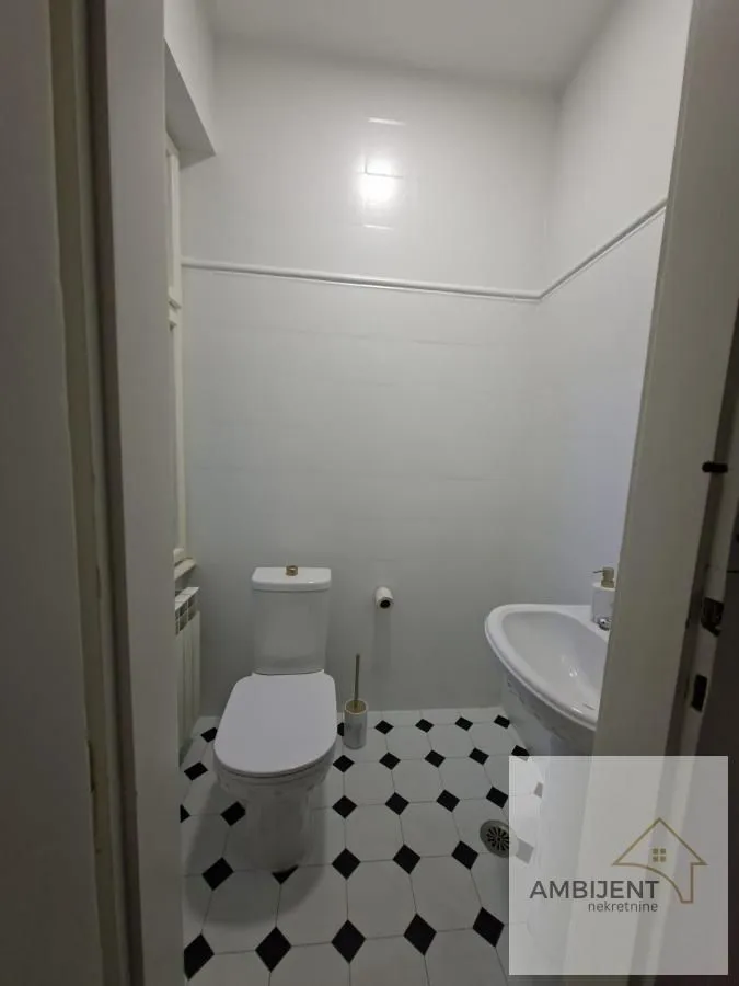 Smaller bathroom with white tiles and sanitary ware.