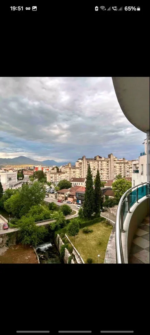 View from the balcony overlooking the city, river, and surrounding greenery.