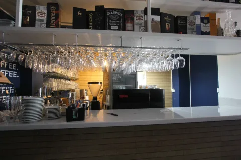 Restaurant bar with drink shelves and glass racks. - image 6
