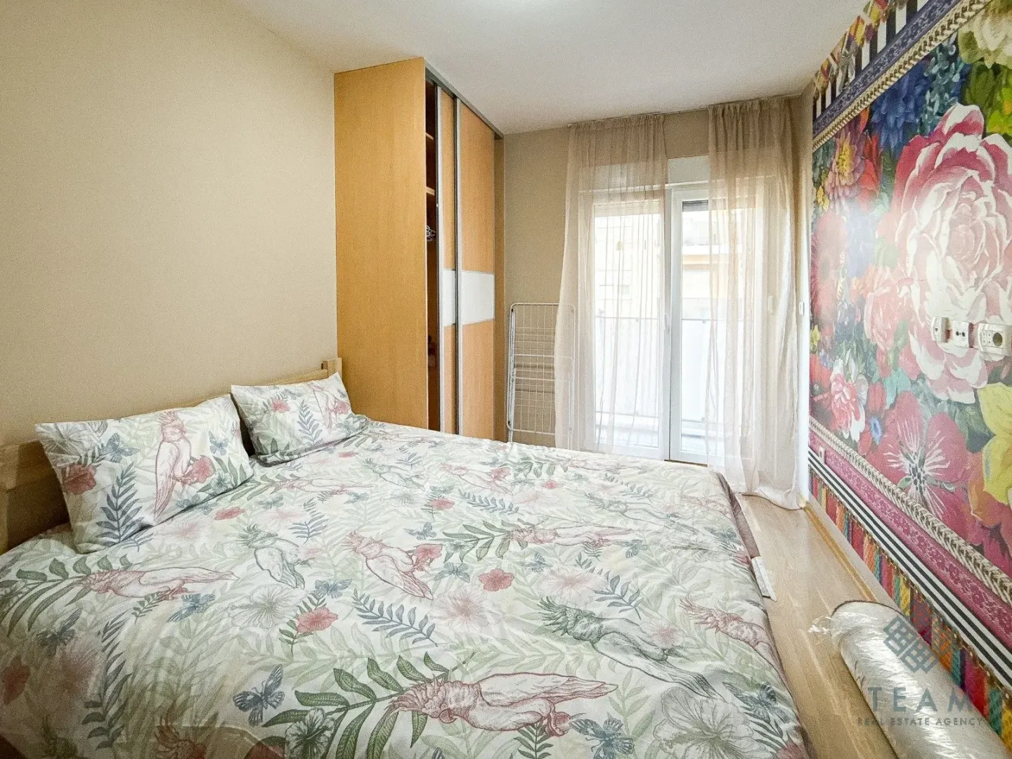 Bedroom with a double bed, wardrobe, and access to the terrace.