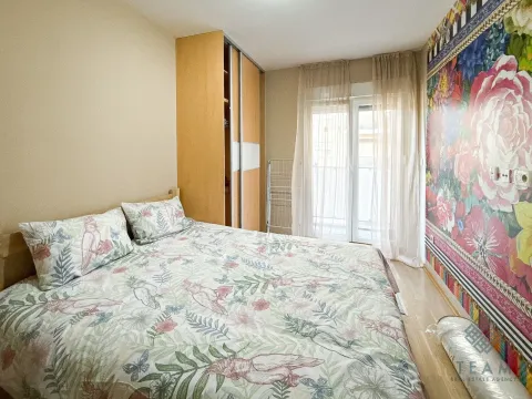 Bedroom with a double bed, wardrobe, and access to the terrace. - image 6