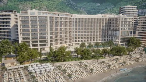 Pogled na spoljašnjost modernog hotela sa uređenom plažom u prvom planu. - image 6