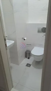 Smaller bathroom with white tiles, washbasin and toilet bowl. - image 5