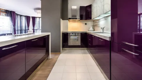 Modern kitchen with dark purple cabinets and built-in appliances. - image 6