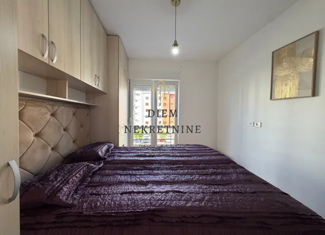 Bedroom with a double bed, built-in wardrobes, and access to the terrace.